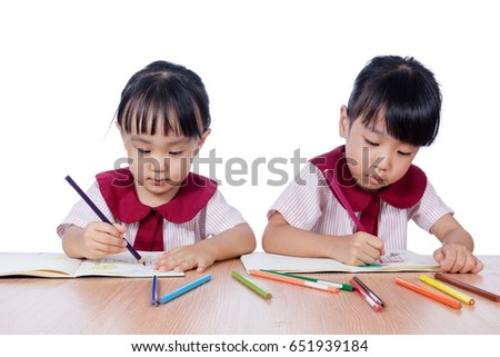 Asian Little Chinese girls drawing with color pencils in isolated white background