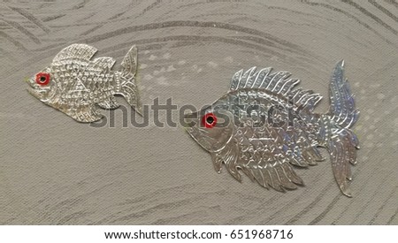 Silverfishes made of gold aluminum decor on wall