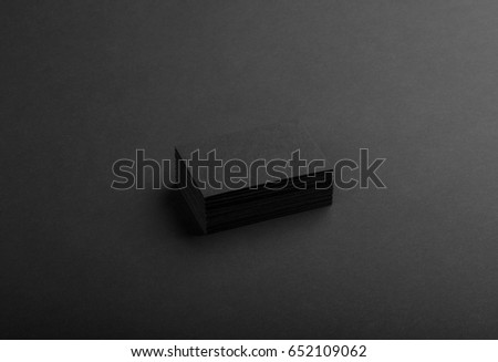 Photo of black business cards. Dark template isolated on black background. For graphic designers presentations and portfolios. Business card mock-up black ob black.