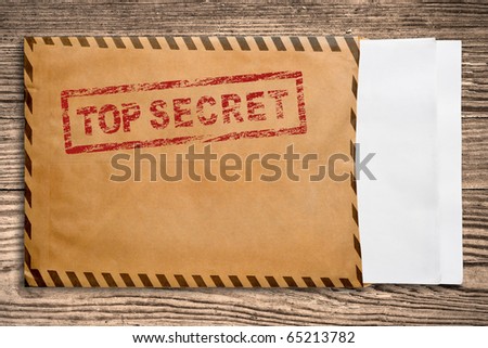 Open yellow envelope with top secret stamp and blank papers, on wooden table, clipping path. Royalty-Free Stock Photo #65213782