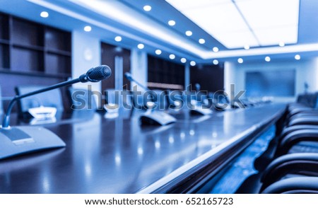 Microphone over the Abstract blurred photo of conference hall or seminar room background