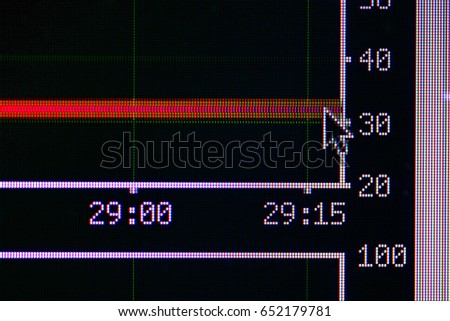 Macro shot of computer screen with numbers, arrow and lines. Grid of small pixels
