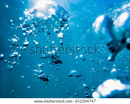 Bubbles underwater in tropical sea. Water texture in ocean