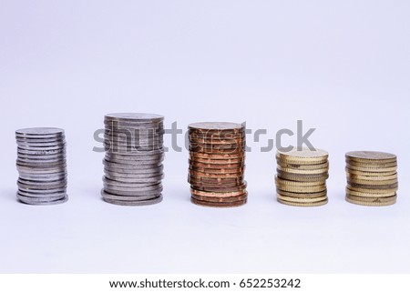 stacks of coins against white studio background