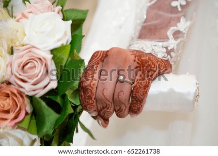 bride holding bouquet stem showing ring
