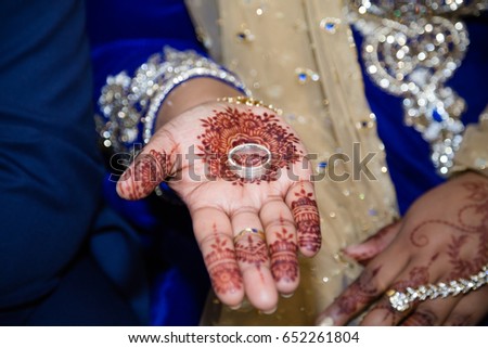 Indian bride holding wedding rinf in hand