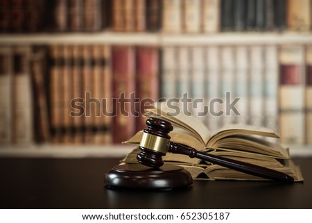 Judge hammer, scales of justice and law books in court