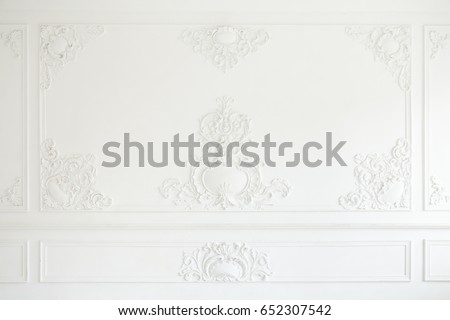 An elegant panel on a white wall made using stucco moldings Royalty-Free Stock Photo #652307542