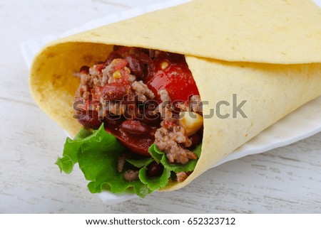 Burrito with beef, salad, beans and sauce