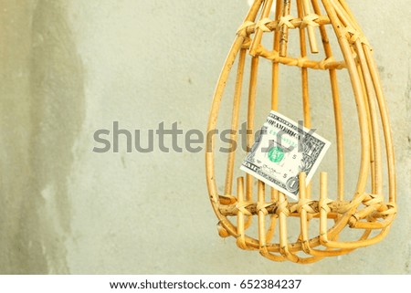 Wooden made fruit picker and banknote made from rattan represent agricultural tool concept idea.