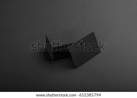 Photo of black business cards. Dark template isolated on black background. For graphic designers presentations and portfolios. Business card mock-up black ob black.