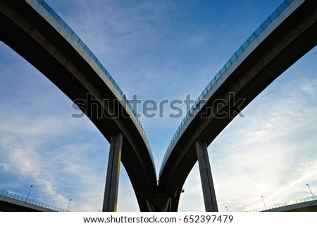 Two routes of elevated highway meet each other.  Royalty-Free Stock Photo #652397479