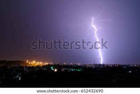 Blue light of the lightning thunderstorm from the clouds and the dark sky in the stromy weather of the rainy season.