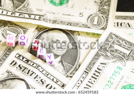 The currency banknote with small plastic cubic in word money represent the business and finance concept related idea.