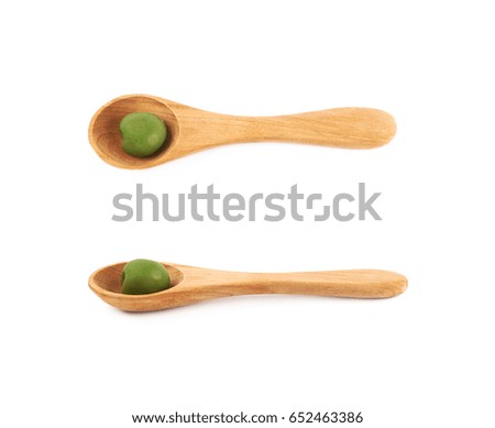 Single olive in a wooden spoon, composition isolated over the white background, set of two different foreshortenings