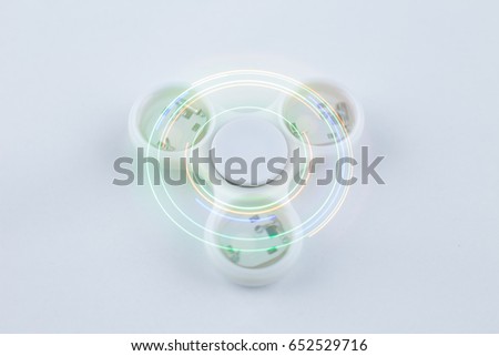 Fidget spinners with led light, stress relieving toy. Motion blur due to slow shutter speed applied