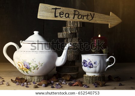 Tea Party. Cup of Tea and Teapot On Wooden Table With Arrow Sign in the Background