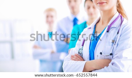 Attractive female doctor in front of medical group Royalty-Free Stock Photo #652557844