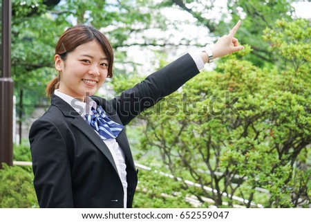 Student pointing to something in uniform