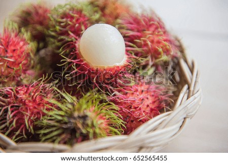 fresh rambutan sweet delicious in the basket . tropical fruit .