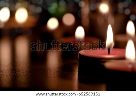 Prayer and hope concept - Retro candle light in the Church with blurred background . Vintage image and selective focus .