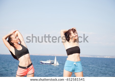 two girls play sports fitness on the beach