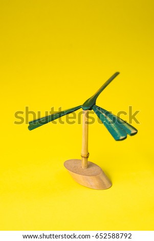 hand made bamboo dragonfly on yellow background