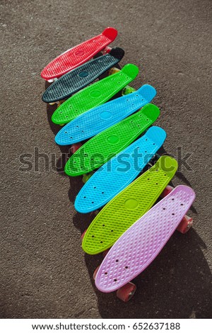 Colourful skateboards. Skateboards on asphalt.