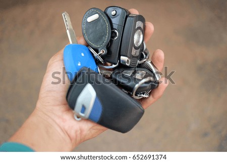 Many of the car keys are in the hands of men.