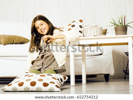 little cute brunette girl at home interior happy smiling close up