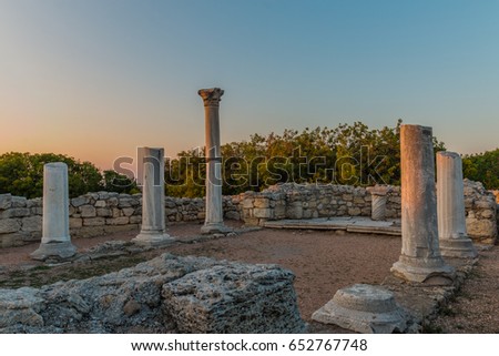 An HDR photo of Basilica inside basilica, museum Chersonesos (Chersonesus) Taurica near Sevastopol, Crimea, Russia. Ancient Byzantine and Greek ruins and columns, and green bushes at the background.