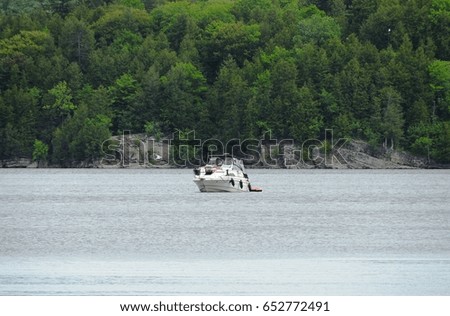 A little boat sails along the river