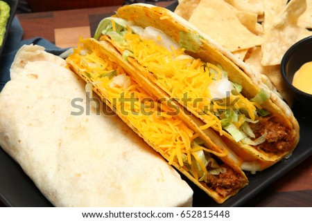 Burrito, Taco, Gordita Crunch and Nachos with Cheese Sauce on Dish.