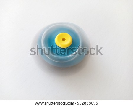 blue fidget spinner stress relieving toy on white background. motion blur , too soft, out of focus, overexposed   