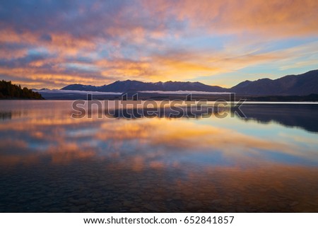 Sunrise at Lake Tekapo with nice reflections - Orange Edition