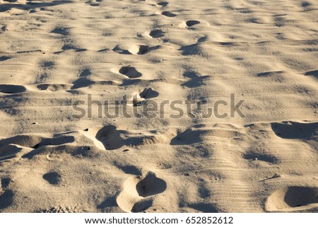 Photograph of beach sand with foot prints