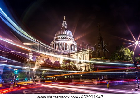 Beautiful shot of St paul cathedral in London taken using Long exposure with double decker red bus passing and creating long light trails