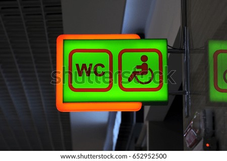 Social infographics. A pointer to common areas for people with disabilities with wheelchairs. Photo partially toned