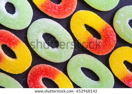 Multicolored marmalade of sweets on a dark background for a template background