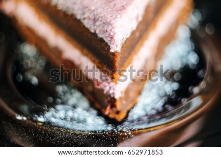 Layered chocolate cake on a plate extreme close up. Shallow depth of field very soft picture