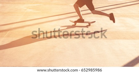 Skateboarder riding skateboard through the streets.