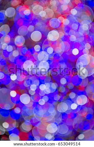 Colorful abstract bokeh background in patriotic red, white, and blue light bubbles on night background