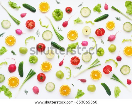  Pattern of vegetables and fruits. Food background.Top view.Composition of pears, green peppers, cucumbers, green radish, tomatoes, green apples, pink radishes and oranges  on a white background. Royalty-Free Stock Photo #653065360