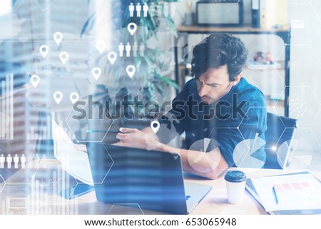 Concept of digital screen,virtual connection icon,diagram,graph interfaces.Businessman working at coworking place on modern notebook.Young man analyze stock reports.Blurred background,horizontal
