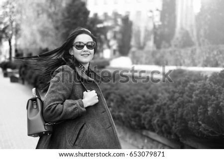 Woman with streaming hair outdoor on the street, black and white