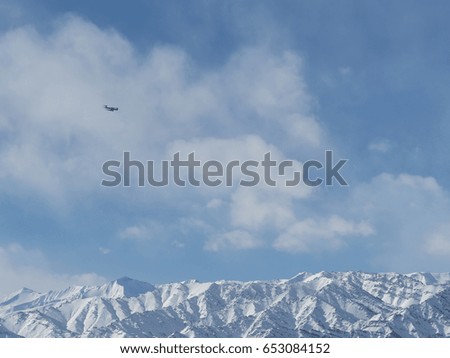 Blue sky with snow mountain and plane move over, background space for lay about journey text 