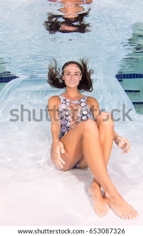 Attractive model wearing a swimsuit underwater.