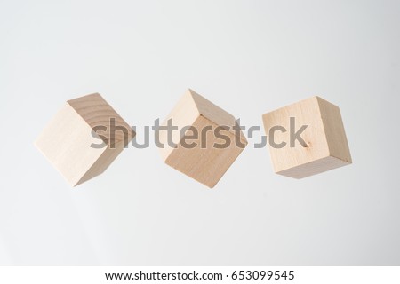Business concept - Abstract geometric real floating wooden cube on grey background and it's not 3D render.