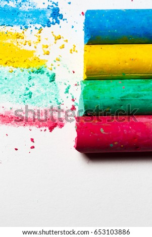 Close up of multicolor chalk on white background. Chalks in a variety of colors arranged on a White background