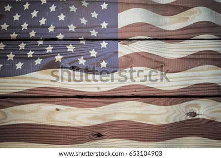 Vintage American Flag painted on aged, weathered rustic wooden Background.